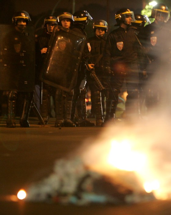 French riot police secure the northeastern Paris suburb of Montfermeil on Saturday after gangs torched public buses overnight.