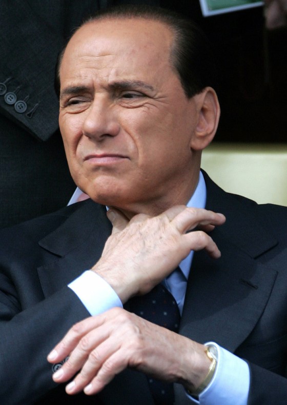 File photo of Italy's former PM Berlusconi adjusting his tie while watching a military parade in Rome