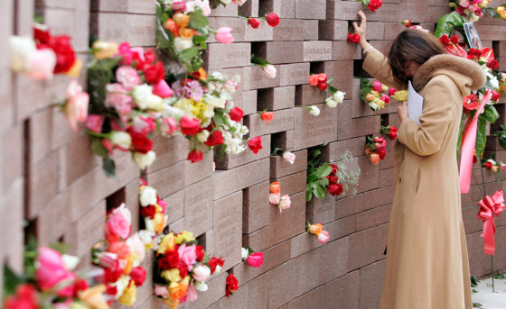 Nannette Forteza rests her hand on the name of her husband during the Sunday dedication of the Flight 587 memorial on the fifth anniversary of the crash in New York City.