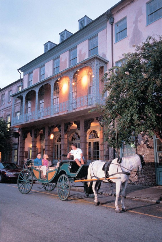A couple takes a carriage ride in front of Historic Dock Street Theater, in Charleston.