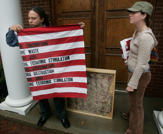 Artists William Gentry, left, and Megan Ellis display one of the U.S. flags and a deep-fried flag that were removed Wednesday in Clarksville Tenn. from an exhibit at the Customs House Museum.
