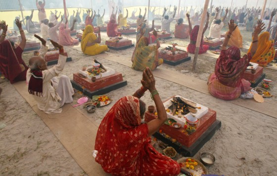 Hindus participate in a mass holy offering using fires in Howra, India on Friday
