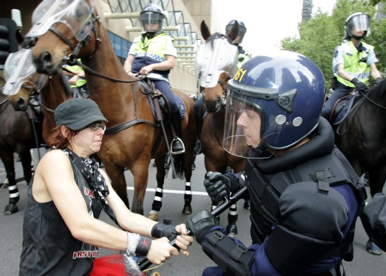A protestor struggles to take away a police officer's baton during a demonstration at the G-20 Finance Ministers and Central Bank Governors meeting in Melbourne, Australia, on Saturday. 