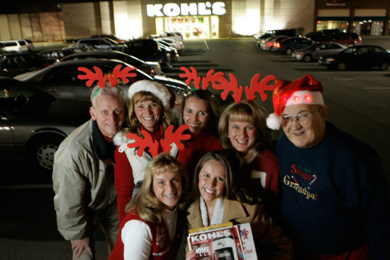 Tammy Dorion, front left, and Megan Dorion, front right, gather with their family Rick Wethrill, from back left, Sherry Dorman, Sarah Chapman, Debby Waters and Jerry Jenkins in front of a Kohl's department store, Monday in Columbus, Ohio. After they've finished their Thanksgiving feast, the family plans the next traditional gathering — shopping on Black Friday.