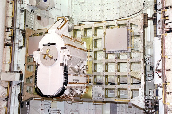 The Early Ammonia Servicer, a piece of equipment that weighs as much as a heavy grand piano, sits on a rack inside a shuttle cargo bay. The EAS was delivered to the international space station aboard the shuttle Discovery in 2001, and will soon be jettisoned into space.