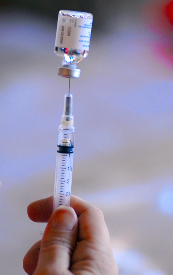A nurse extracts a flu vaccine from a vial as San Luis Obispo County public healthcare professionals conduct a mass flu vaccination drill at the Veterans building in San Luis Obisbo