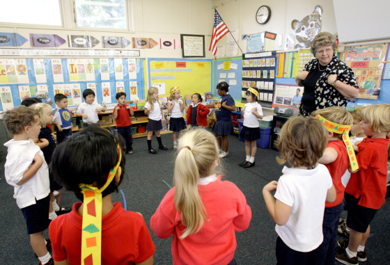 Teacher Becky Wyatt, right, oversees rehearsals for the annual Thanksgiving Day play at Kettering Elementary School in Long Beach, Calif., on Friday. For years, students in her class have not used feathers for their American Indian headbands because they are considered sacred objects in Native American culture.
