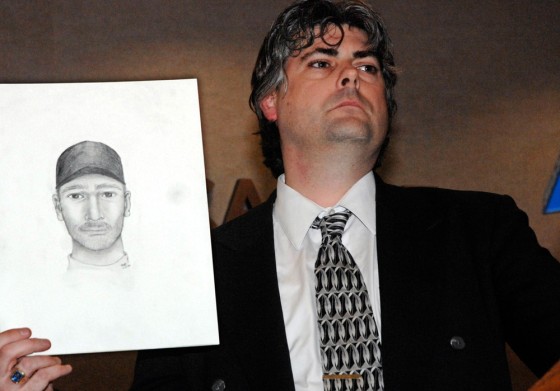 Police detective Sgt. Marc Simmons holds a sketch of a possible murder suspect during a press conference in the town of Newcastle, N.Y., near the Chappaqua residence of former President Bill Clinton, on Monday. 