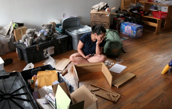 Sgt. Leana Nishimura assembles shelving at her newly rented home in Havre de Grace, Md. Her children have been staying with her mother in Hawaii. She's unpacking and preparing the house for the arrival of her two boys, T.J., 8, and Dylan, 7, and her daughter Cheyenne, 4.