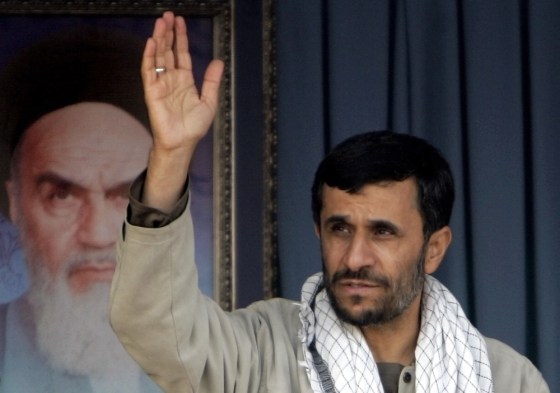 Iranian President Ahmadinejad waves to Basij paramilitary volunteers during parade ceremony in Tehran