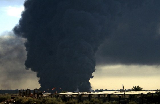 Smoke rises from a fuel installation in