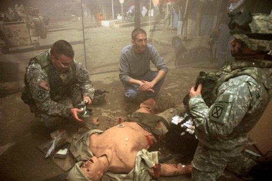 Spc. Josh Demasi, left, and Sgt. Cory Surla, right, critique their work with Tactical Medicine Educator Christopher Scott at the Medical Simulation Training Center at Fort Drum, N.Y., Friday, Nov. 17, 2006. The center is one of 18 new training facilities the Army is building worldwide to improve its combat medic training.