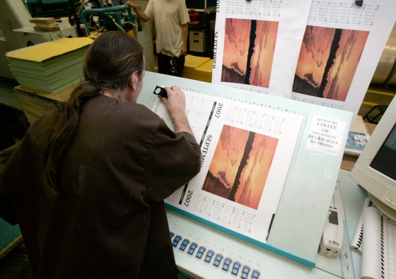 An inmate checks the quality of a calendar being printed at the Maryland Department of Corrections in Jessup, Md., Sept. 6, 2006.