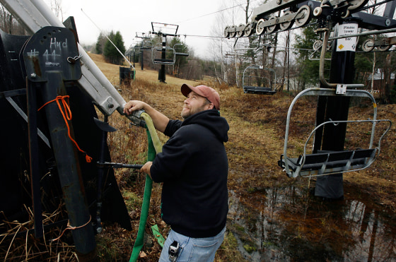 Greg Warner adjusts the angle of a snow gun earlier this month at Sunday River in Newry, Maine. In time for the new ski season, several Northern New England ski areas, including Sunday River, are becoming part of a national trend of resorts going "green" by buying wind-generated electricity to power their energy-hungry operations.