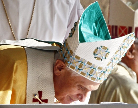 Pope Benedict XVI kisses the altar at the end of a mass in front of 'Mary's House' near Ephesus