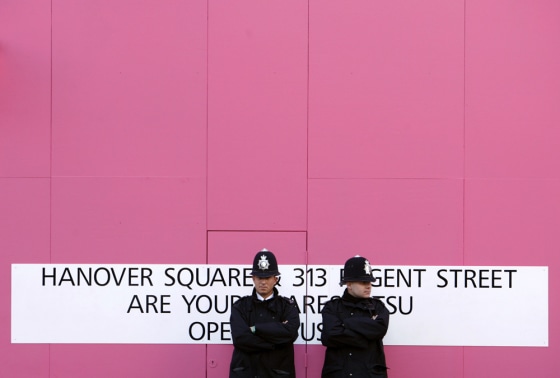 Policemen stand guard outside the Itsu restaurant in the Piccadilly area of central London