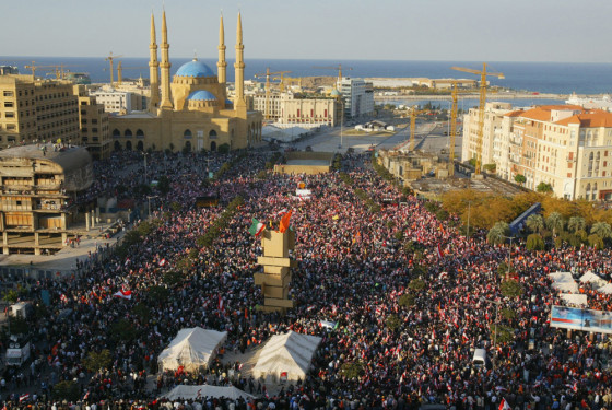 Lebanese pro-Syrian groups wave national flags during a rally in Beirut