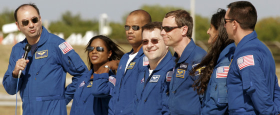 The crew of Shuttle Discovery pose near launch pad 39B at Kennedy Space Center in Cape Canaveral