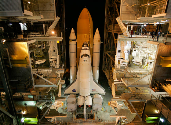 The space shuttle Discovery rolls out from the Vehicle Assembly Building at NASA's Kennedy Space Center in Florida in November, on its way to Launch Pad 39B. Months of preparation are leading up to Thursday's launch, the shuttle program's first nighttime blastoff in four years.