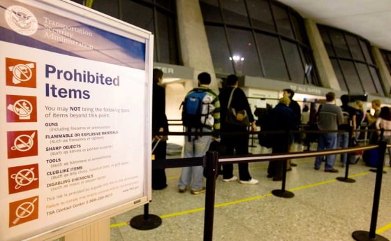 Passengers wait at a security checkpoint at Dulles International Airport in Dulles, Va. on Nov. 11. For the past four years without public notice, federal agents have assigned millions of Americans and other international travelers computer-generated scores assessing the risk they pose of being terrorists or criminals. 