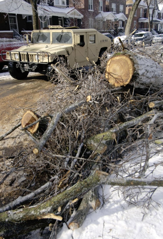 A Missouri National Guard Humvee patrols a neighborhood in St. Louis to assist residents without power on Saturday. 