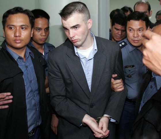 U.S. Marine Lance Cpl. Daniel Smith, center, is escorted by Philippine police at the Makati Central Police Station on Monday. Smith has been sentenced to 40 years in prison for the rape of a Filipino woman.
