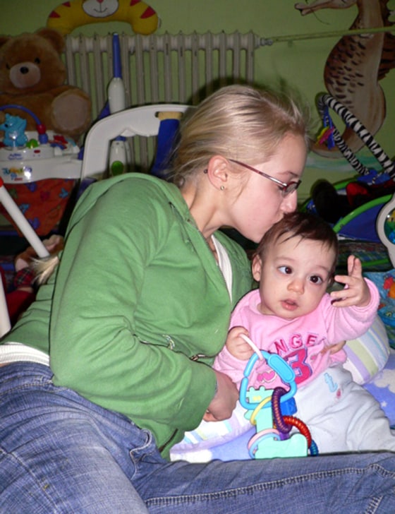 Lilly Fisher gives a kiss to a boy named Abel while volunteering at Tutova Hospital's Failure to Thrive Clinic in Tutova, Romania earlier this year.
