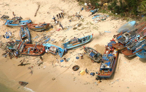 Fishing boats were washed ashore after Tropical Storm Durian tore through Phu Quy island off the coast of Binh Thuan province, Vietnam, on Tuesday.
