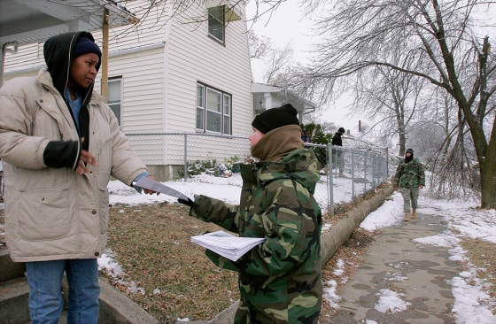 Illinois Army National Guard member Brittany Nora, right, checks on Tuesday on resident Vivian Palmer, who is still without electricity from last week's ice storm in Decatur, Ill.