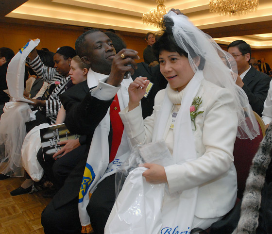 The Rev. Bismark Bamfo, of Boston, adjusts the veil of his wife, Bibiana, before ceremonies to reaffirm their marriage vows in Parsippany, N.J., on Dec. 9.