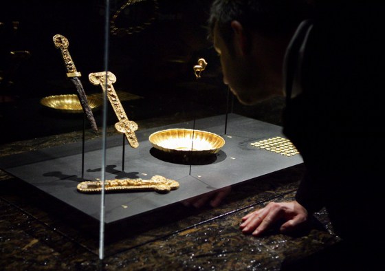 Visitors take a look at some of the glittering items presented at Guimet Museum in Paris on Monday, as part of an exhibition of Afghanistan's treasures. These gold items were hidden away for years, by brave art lovers who defied the Taliban and risked their lives to save them.