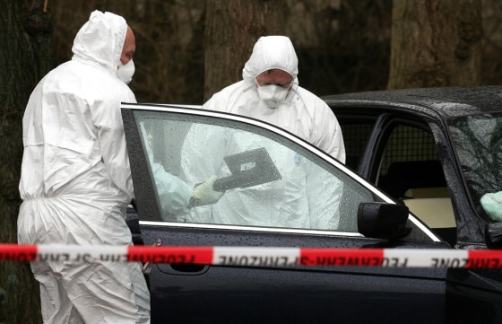 Investigators examine a car on an estate in Haselau, west of Hamburg, Germany, on Monday. Traces of radiation found at sites in Germany linked to a contact of poisoned former Russian spy Alexander Litvinenko likely are the rare radioactive substance polonium-210, authorities said Sunday. 