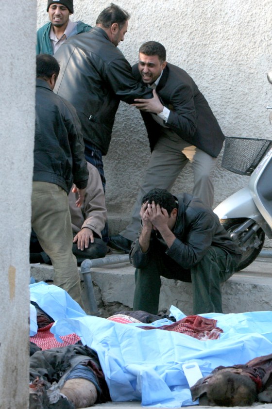 Iraqis at a Baghdad hospital grieve over the bodies of their dead relatives who were killed in a twin bombing on Tuesday.