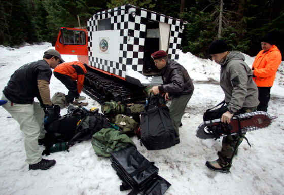 Members of a rescue team load a Snow Cat on Tuesday before searching for three climbers missing on Mount Hood, Ore. The three experienced climbers were reported missing in heavy snow Sunday. 