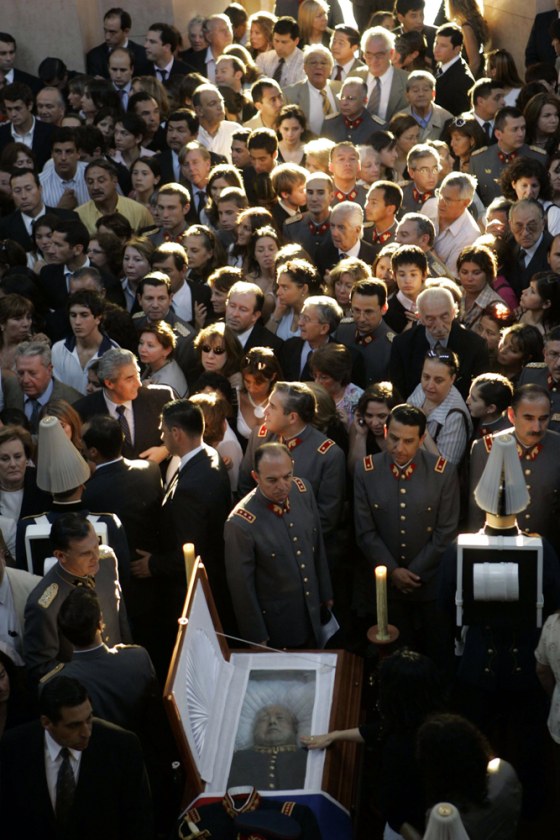 Supporters of former military ruler Gen. Augusto Pinochet attend a Mass at the Military Academy in Santiago on Monday. Pinochet, who ruled Chile from 1973 to 1990 after a military coup, died Sunday from heart complications at the age of 91.