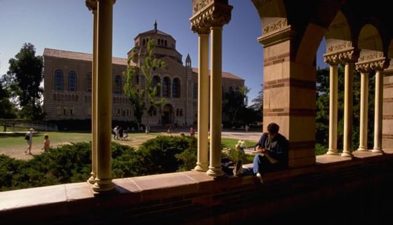 Student Sits Under Arches at Royce Hall