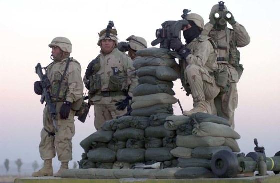 U.S. Marines scan the northwest perimeter of the American military compound at Afghanistan's Kandahar airport. The Marine Corps may need to increase in size to sustain deployments to Iraq and Afghanistan without sacrificing needed training or putting undue stress on the corps.