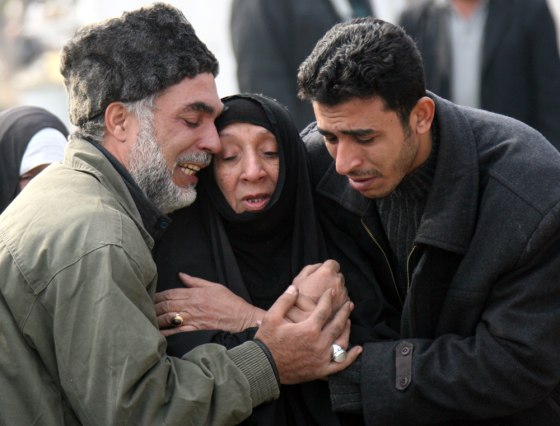 Iraqis cry at a Baghdad hospital on Wednesday after collecting the remains of a relative who was recently killed.