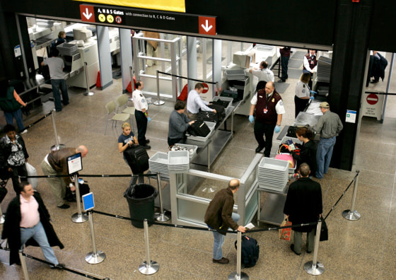 People make their way through security at Seattle-Tacoma International Airport Monday earlier this month. Travelers can expect longer lines as passenger volumes increase as the holidays approach.