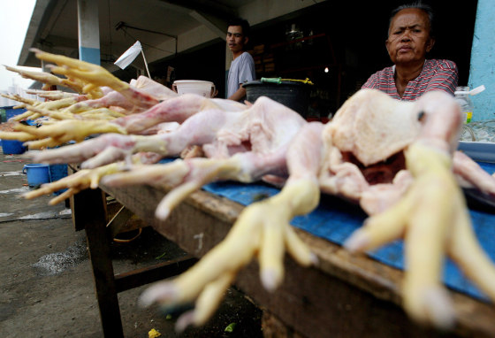 An elderly livestock vendor waits for cu