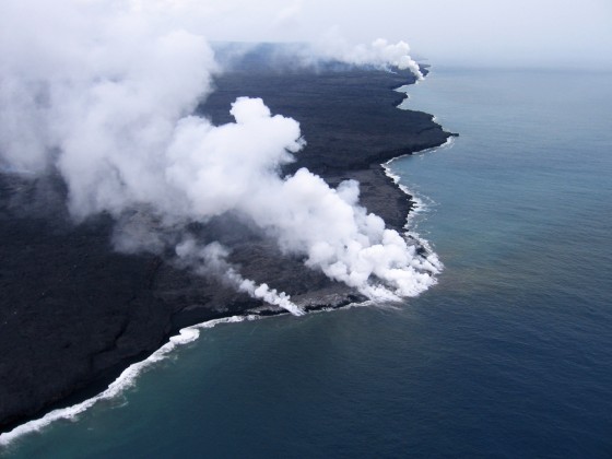 Steam is seen rising from several sites as lava enters the ocean at East Laeapuki, Hawaii. Visitors to one of the world's most active volcanoes are being kept hundreds of feet away from a 55-acre lava delta that authorities believe may soon collapse into the Pacific Ocean. 