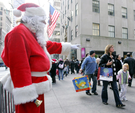 A man dressed as Santa Claus greets chil