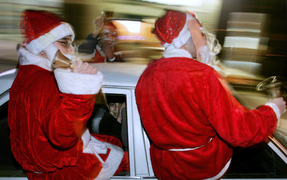Palestinian children dressed as Santa Claus ring bells as they ride on a car during Christmas celebrations in the West Bank town of Ramallah on Sunday.