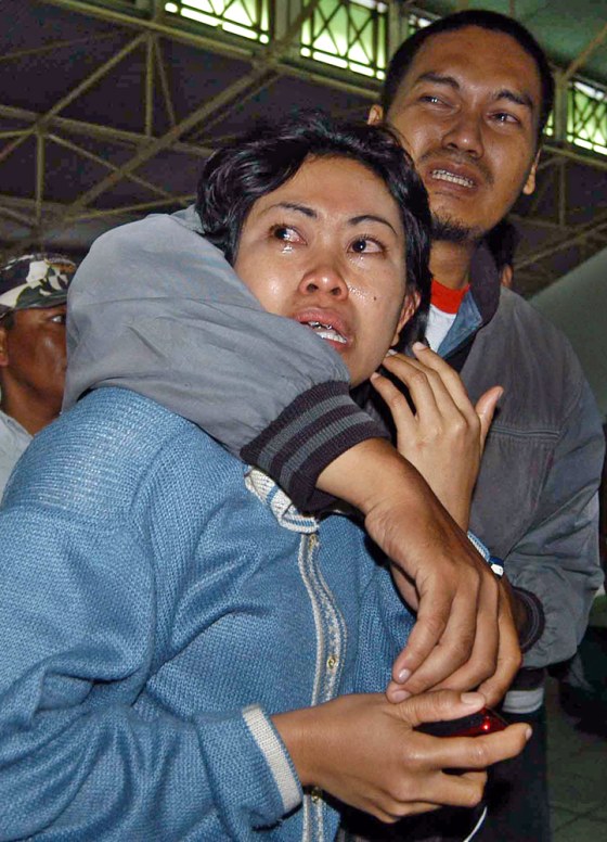 Relatives wait for news on a sunken vessel at Tanjung Mas port in Semarang, Central Java, Indonesia, on Saturday.