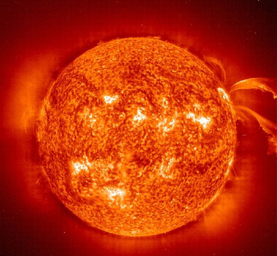 An image from the Solar and Heliospheric Observatory's Extreme Ultraviolet Imaging Telescope captures a pair of curving prominences erupting from the sun on June 28, 2000.