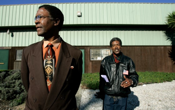 Henry Clark, left, and Johnny White are two of the activists in Richmond, Calif., who blocked the building behind them from becoming a cremoratorium.