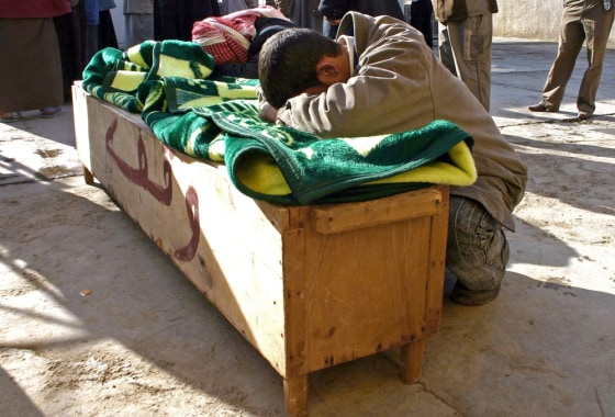 Iraqis mourn over the coffin of a relati