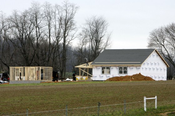 Men are seen working Thursday on structures in Nickel Mines, Pa. A new Amish schoolhouse is rising a few hundred yards from the former site of the school where a gunman shot 10 girls in October, killing five of them.