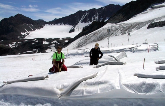Innsbruck University researchers check part of the glacier at Austria's Stubai resort in this July 4, 2005, file photo. That section had been covered with white polyethylene to help protect the glacier from the sun.