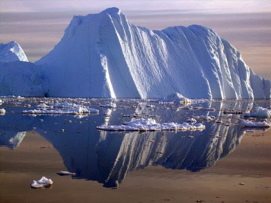 An iceberg carved from a glacier floats in the Jacobshavn fjord in southwest Greenland. Greenland's massive ice sheet is melting much more quickly than scientists had estimated.